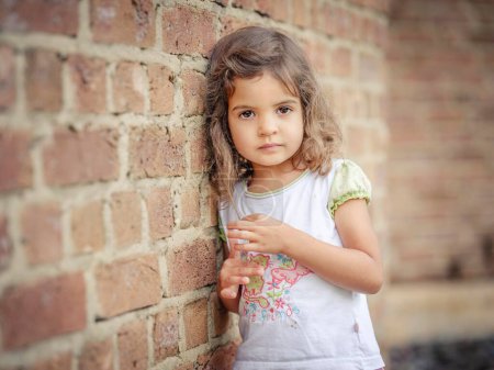 Girl, 3 years old, leaning against a wall, portrait, Germany, Europe