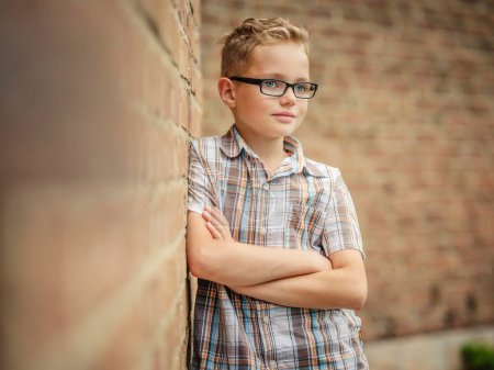 Boy, 9 years, leaning against a wall, Portrait, Germany, Europe