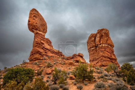 Rock formation Balanced Rock, dark cloudy sky, Arches National Park, near Moab, Utah, USA, North America