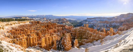 View of the amphitheatre, morning light, snow-covered bizarre rocky landscape with Hoodoos in winter, Rim Trail, Bryce Canyon National Park, Utah, USA, North America