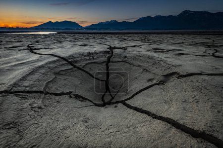 Cracked, dried out soil with small water area and Allgu Alps in the background, Forggensee, Fssen, Ostallgu, Bavaria, Germany, Europe 