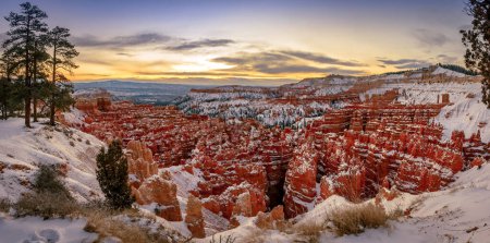 Amphitheatre at sunrise, snow-covered bizarre rocky landscape with Hoodoos in winter, Rim Trail, Bryce Canyon National Park, Utah, USA, North America