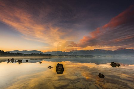 Forggensee with reflection of the cloudy sky and the Allguer mountains in the background at sunrise, Fssen, Allgu, Bavaria, Germany, Europe 