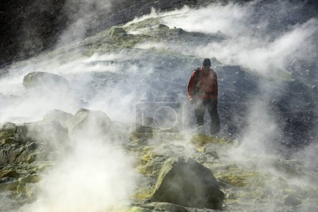 Hiker on the Gran Cratere walks through sulphur fumaroles, Vulcano Island, Liparic Islands, Italy, Europe