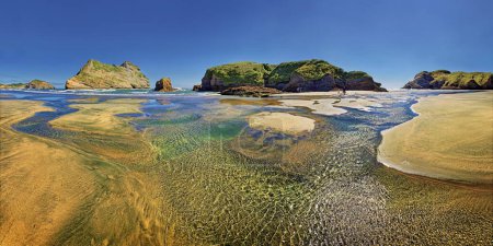 Sandy beach with receding water and rocky island in the surf, Archway Islands, Wharariki Beach, Cape Farewell, Puponga, Tasman Region, Southland, New Zealand, Oceania