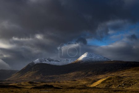 Snowy mountain peaks of Meall aBhiridh and Clach Leathad in the background and dramatic clouds, Glen Coe, Rannoch Moor, west Highlands, Scotland, United Kingdom, Europe 