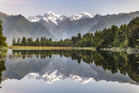 View of snow-covered Mount Cook and Mount Tasman, reflection in Lake Matheson, Westland National Park, Southern Alps, West Coast Region, South Island, New Zealand, Oceania