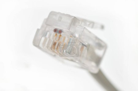 Photo for Cable with Rj 11 plug for a telephone line on an isolated white backgroun - Royalty Free Image