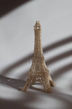 Photo for Miniature of Eiffel tower on the table in sunshine. - Royalty Free Image