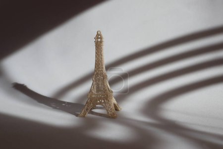 Photo for Miniature of Eiffel tower on the table in sunshine. - Royalty Free Image