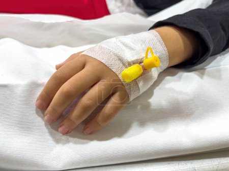 Photo for Vascular access on the hand of young sick girl at the hospital bed - Royalty Free Image