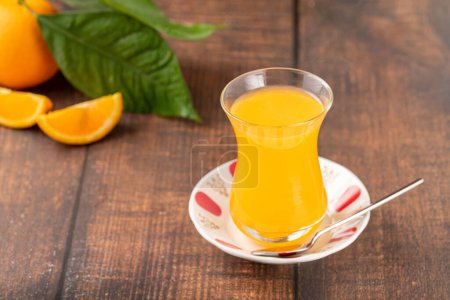 Foto de Winter drink orange oralet or oralette in a thin-waisted glass tea glass - Imagen libre de derechos