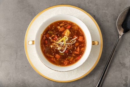 Hot and sour veggie soup on a white porcelain plate
