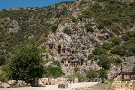 Photo for The ruins of the amphitheater and ancient rock tombs in the ancient city of Myra in Demre, Turkey - Royalty Free Image