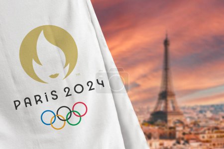 Photo for Antalya, Turkey - August 18, 2023: Paris 2024 Olympic Games flag in front of blurred Paris skyline - Royalty Free Image