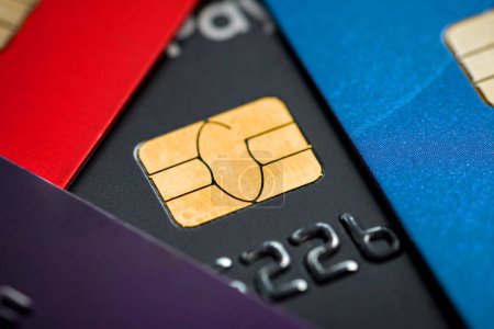 Stacked credit cards with chip, close up view with selective focus for background