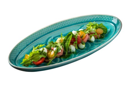 plate with arugula, mozzarella and watermelon salad close-up