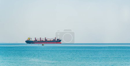 Bulk carrier ship waiting at the port entrance of the city