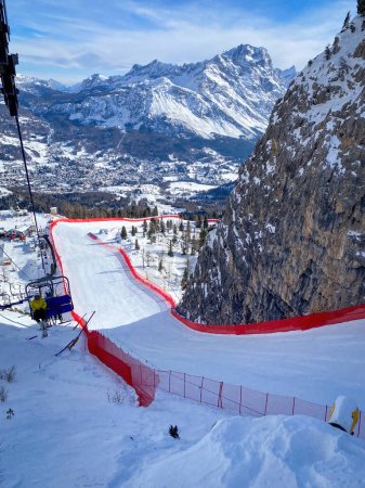Photo for Cortina d'Ampezzo, Italy - January 27, 2023: Scenic view of Tofana ski racing slope in Cortina d'Ampezzo in Italy against snow covered Punta Sorapiss Mountain and blue sky - Royalty Free Image