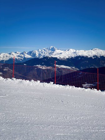 Photo for Scenic view of Mont Blanc mountain, France from a ski slope in Meribel with red safety net - Royalty Free Image
