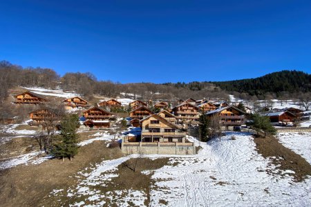 Photo for Chalets near Meribel, France in winter against blue sky - Royalty Free Image