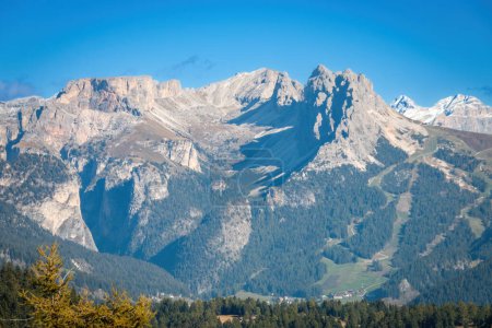 Photo for Scenic view of Pizes de Cir mountain group (right) seen from Seiser Alm Alpe di Siusi, Dolomites, South Tyrol, Italy in autumn against blue sky - Royalty Free Image
