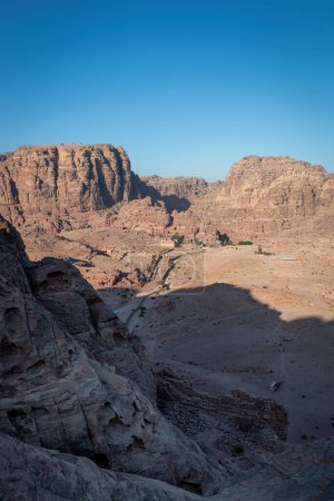 Photo for Scenic view of Colonnaded Street, Great Temple and Qasr al-Bint in the historic and archaeological city of Petra, Jordan from Al-Kubtha Trail against blue sky - Royalty Free Image
