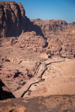 Photo for Scenic view of Colonnaded Street, Great Temple and Qasr al-Bint in the historic and archaeological city of Petra, Jordan from Al-Kubtha Trail against blue sky - Royalty Free Image