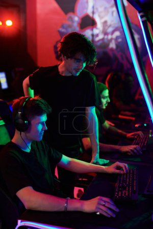 Photo for Esports coach giving advice to gamer while preparing him for cybersport tournament - Royalty Free Image