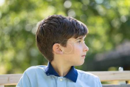 Photo for Close up portrait front view of serious young boy looking away - Royalty Free Image