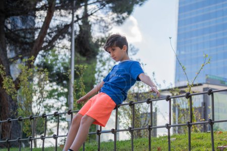 Photo for Child in a park practicing balance in Madrid downtown centre - Royalty Free Image