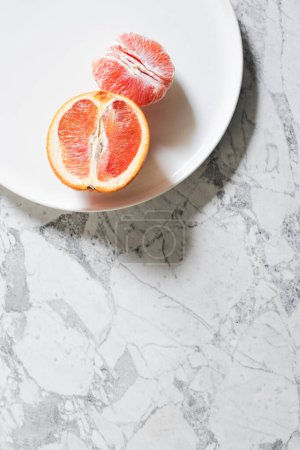 Photo for Minimal Red Navel Orange Flat Lay on White Marble - Royalty Free Image