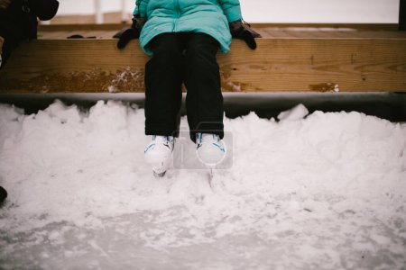 Photo for Child in ice skates and snow clothes ready to skate out - Royalty Free Image