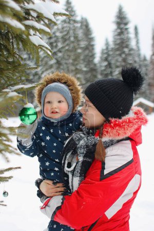 Téléchargez les photos : Mère et fils regardant jouet sapin de Noël - en image libre de droit
