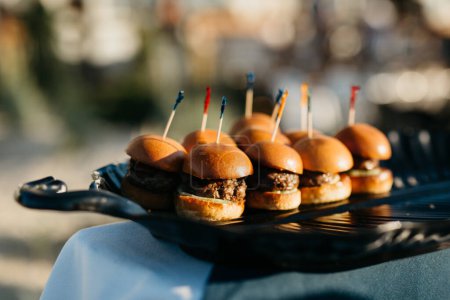 Photo for A platter of beef sliders on a table outside for an even - Royalty Free Image