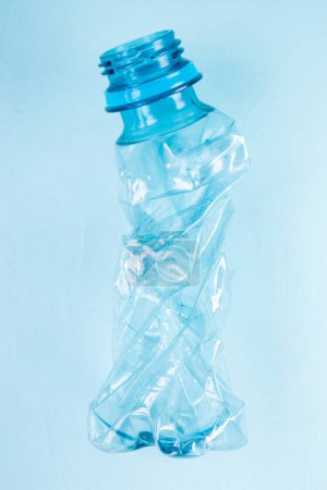 Photo for Close up of plastic stripped bottle on blue background - Royalty Free Image