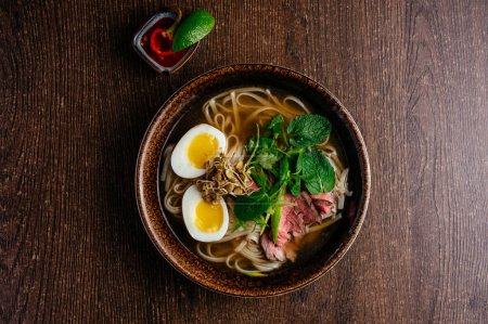 Photo for Vietnamese national pho soup on a wooden table - Royalty Free Image