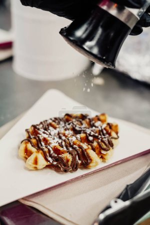 Photo for Delicious waffle with chocolate syrup to take on the go - Royalty Free Image