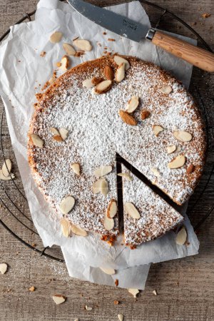 Photo for Whole almond cake with single slice cut - Royalty Free Image