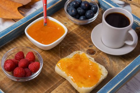 Photo for Healthy breakfast on a wooden tray,homemade jam,berries and coffee - Royalty Free Image