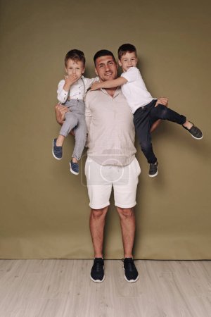 Photo for Father and two sons, parenting - Royalty Free Image