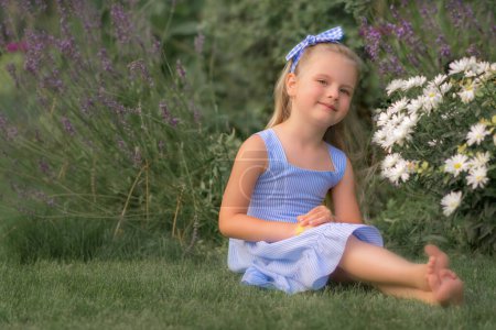 Photo for Girl in the meadow looking at the camera - Royalty Free Image