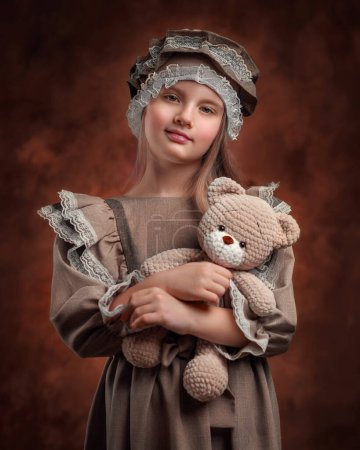 Photo for Girl in a suit holding a toy - Royalty Free Image