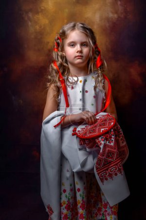 Photo for Girl in Ukrainian dress embroiders - Royalty Free Image