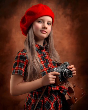 Photo for Girl in a red beret holding a camera - Royalty Free Image