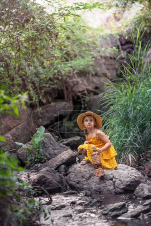 Photo for Girl fetching water from a mountain stream - Royalty Free Image