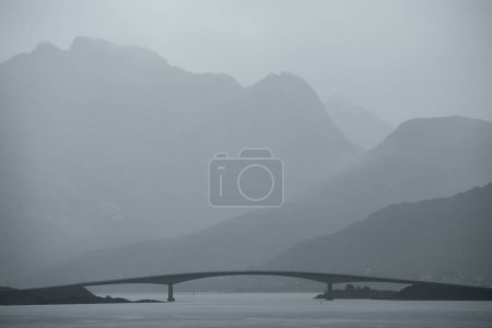 Photo for Fredvang bridge and surrounding mountains in misty rain, Flakstady, Lofoten Islands, Norway - Royalty Free Image
