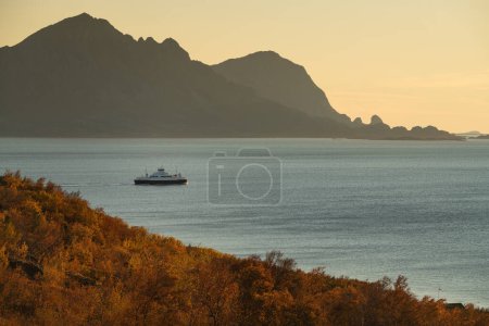Photo for Evening ferry leaving from Stokkvgen along the Helgeland coast, Nordland, Norway - Royalty Free Image