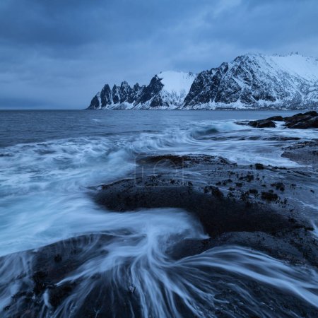 Photo for Waves flow over rocky coastline at Tungeneset, Senja, Norway - Royalty Free Image
