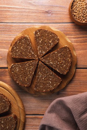 Photo for Homemade rye bread with seeds on a wooden board - Royalty Free Image